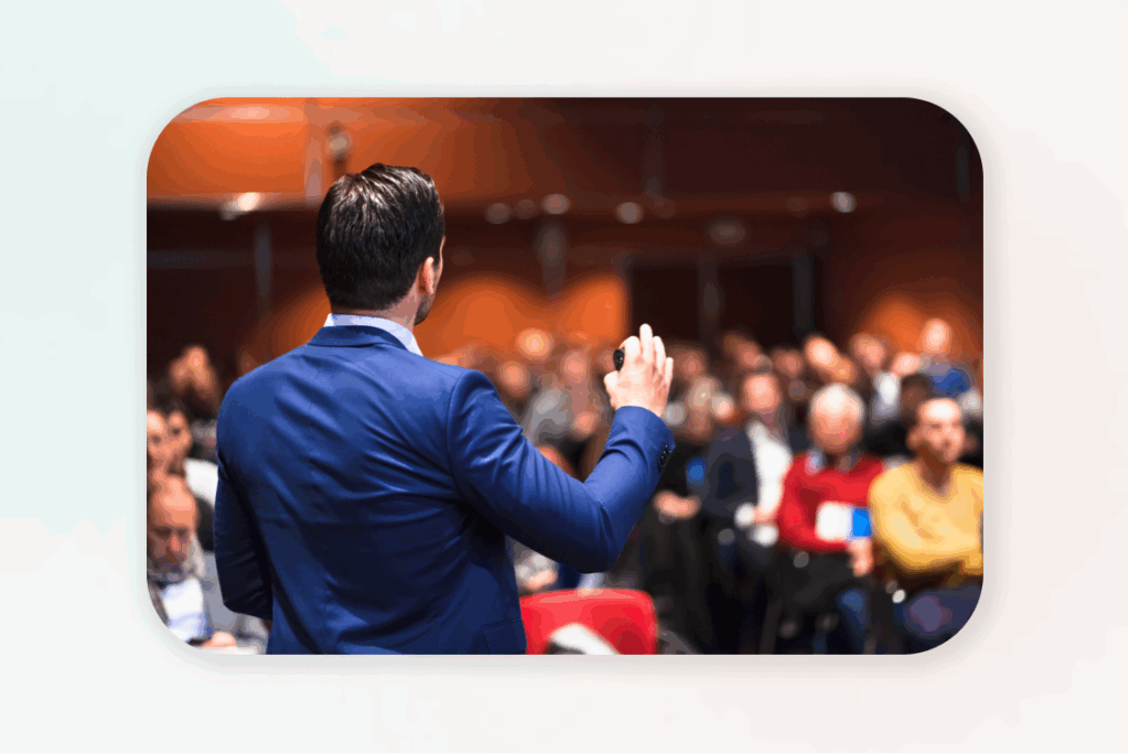 Businessman giving presentation to audience about making money online.