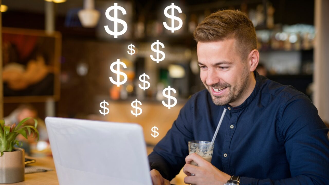 Guy with laptop and money signs representing online revenue