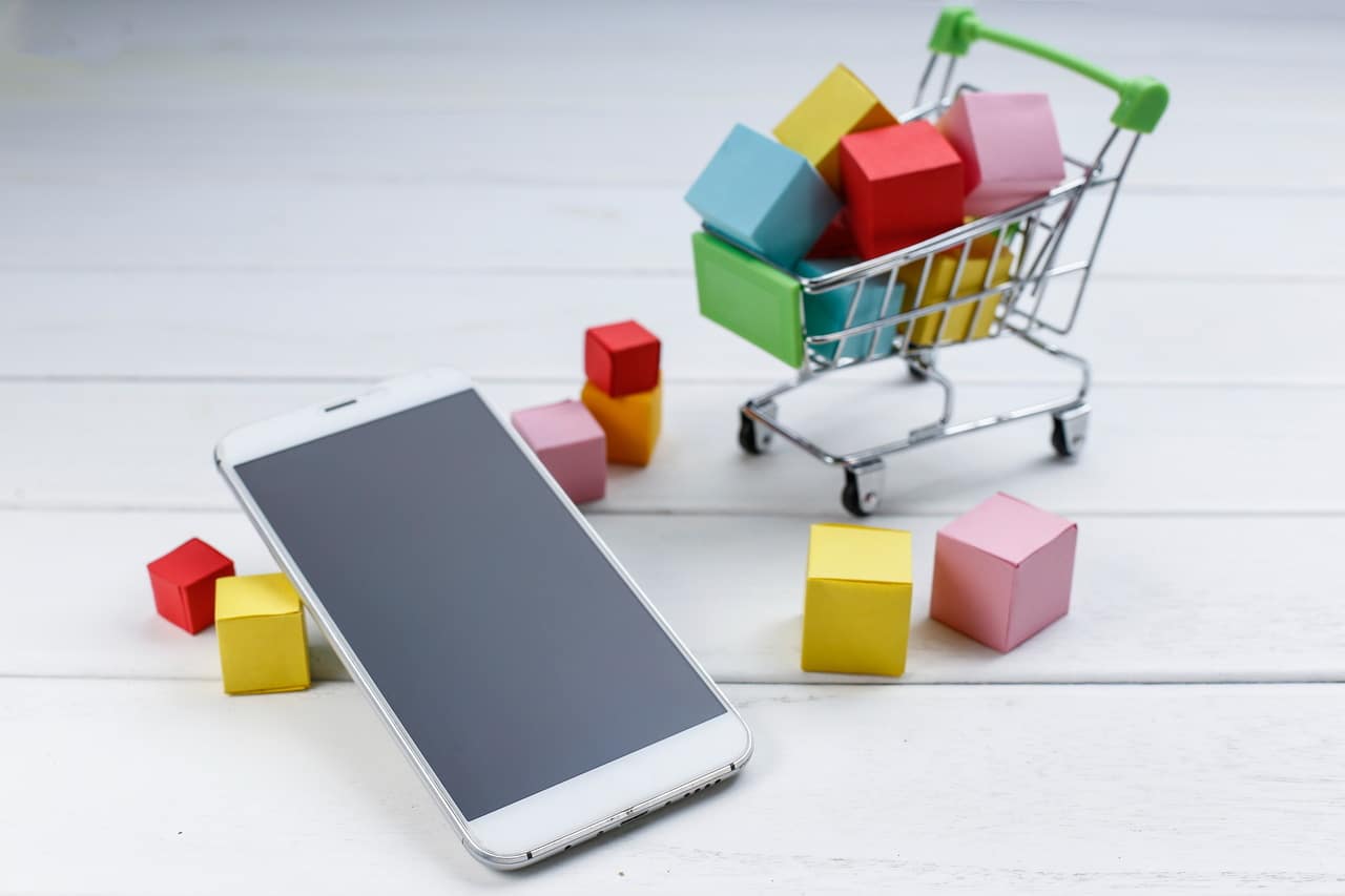Trolley and phone representing selling digital products online