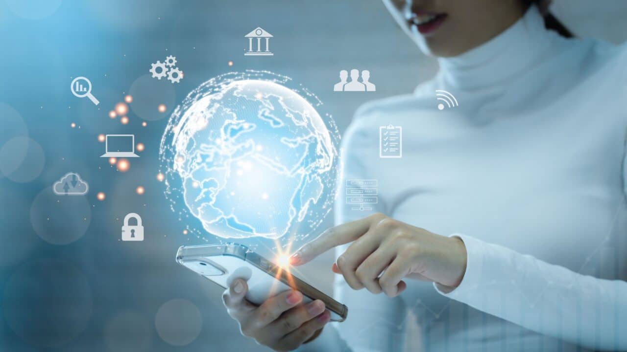 1_woman_using_smartphone_with_digital_globe