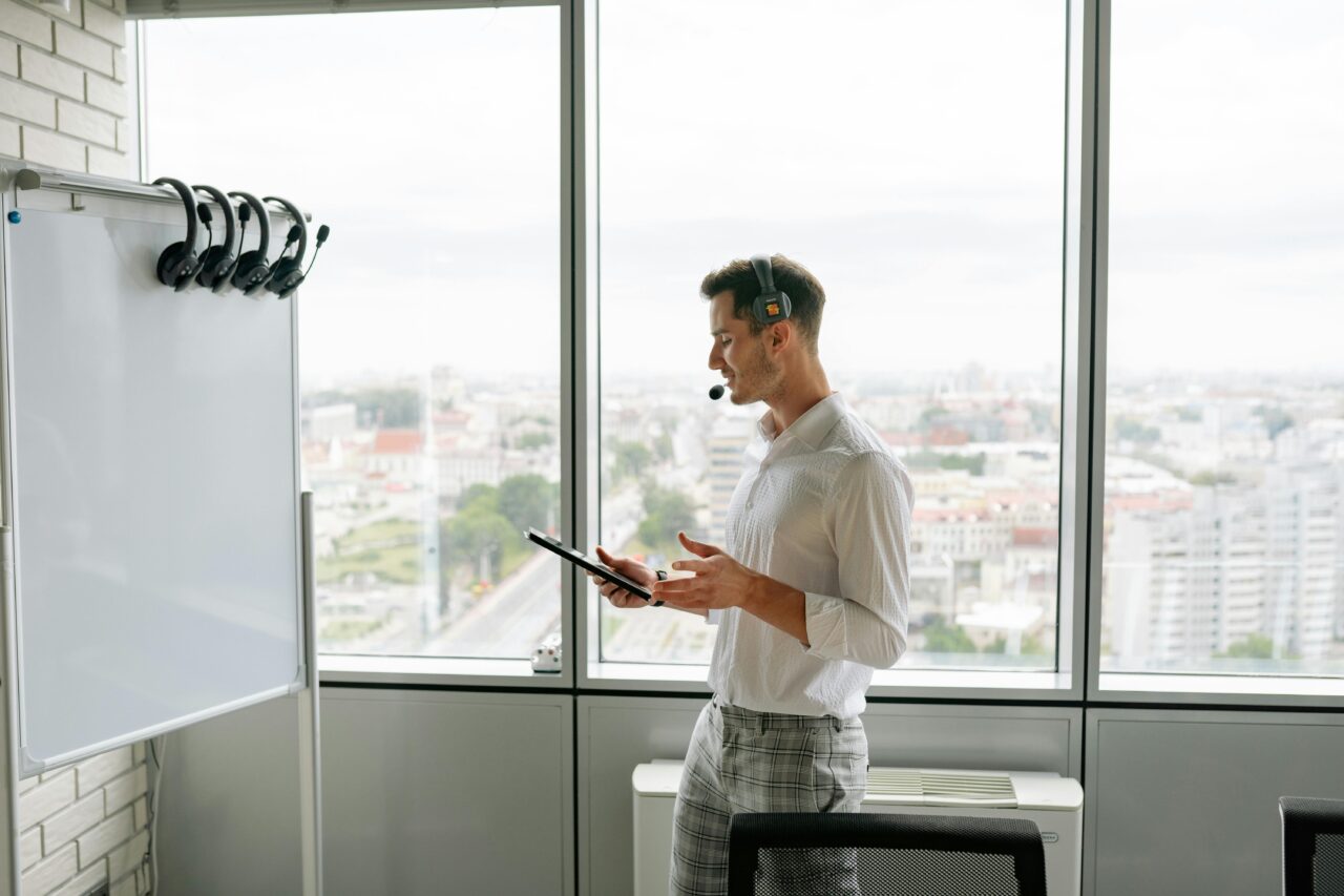 Someone creating a digital guide on computer with notes and planning materials