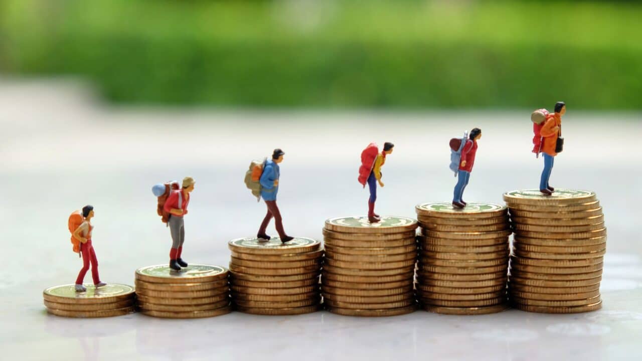7_financial_growth_journey_hikers_on_coins