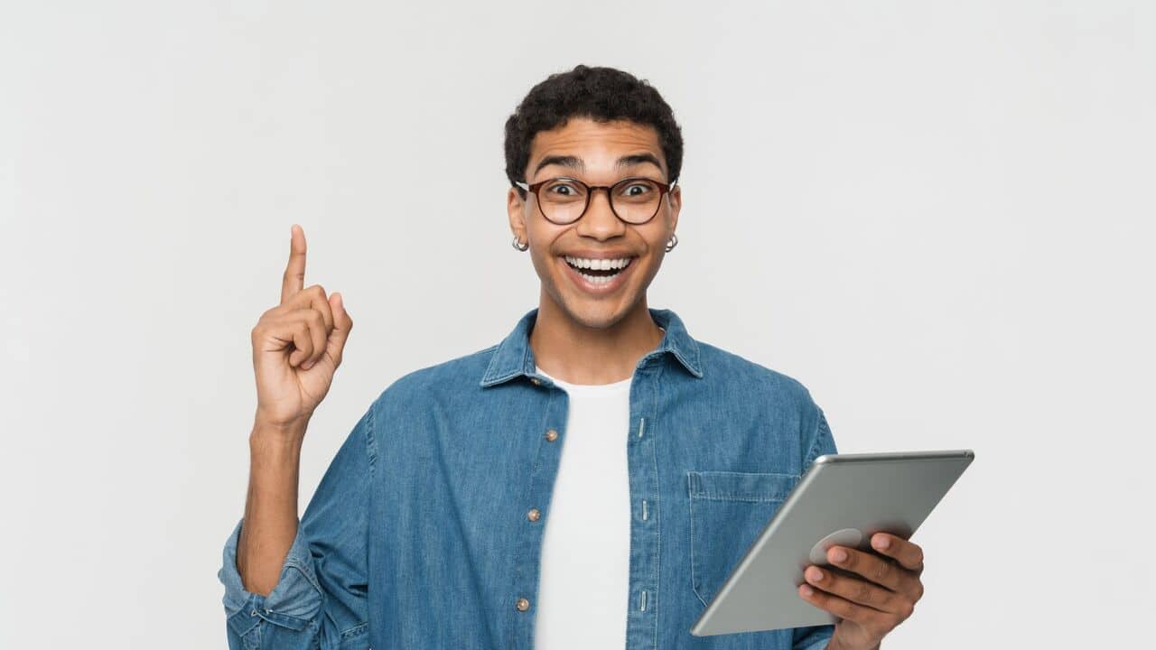 Guy pointing his finger upwards smiling