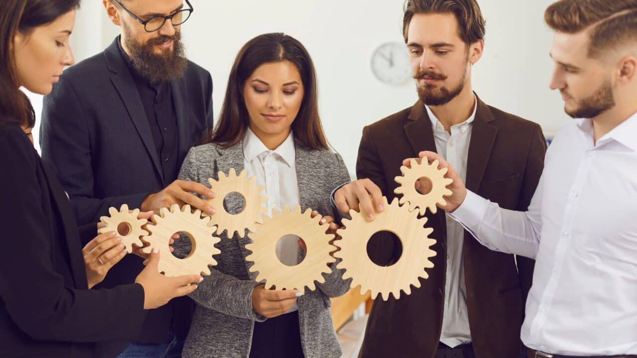 9_team_holding_gears_workflow_collaboration