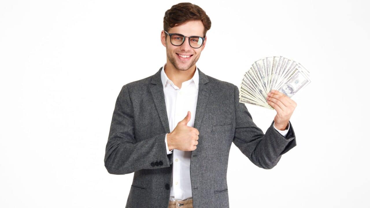 10_businessman_giving_thumbs_up_holding_cash_success