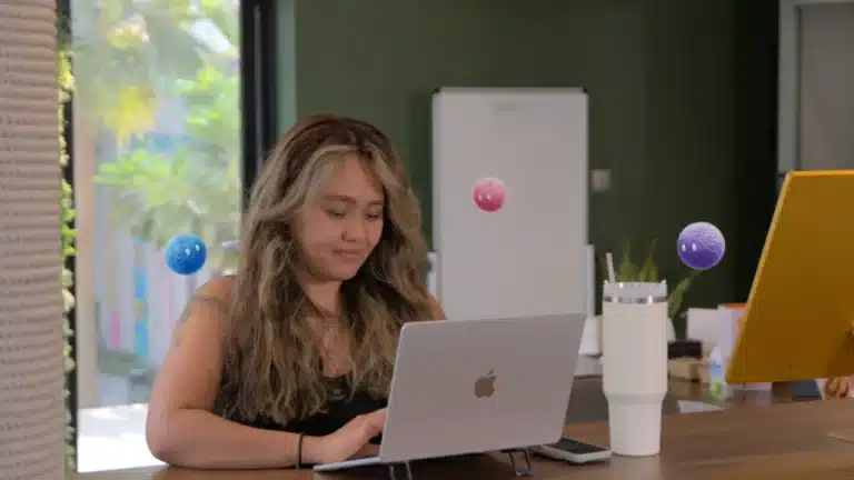 Marketer working independently on a laptop with Nas AI agents nearby.