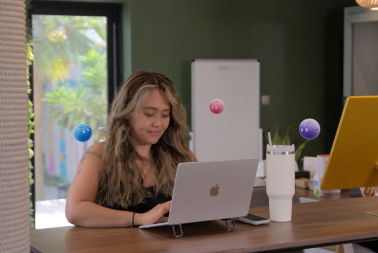 Marketer working independently on a laptop with Nas AI agents nearby.