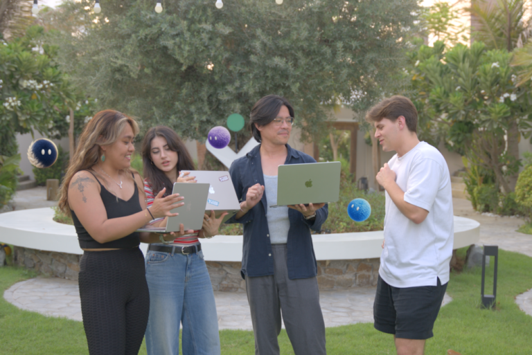 Team collaborating outdoors on laptops and a tablet with Nas AI agents.